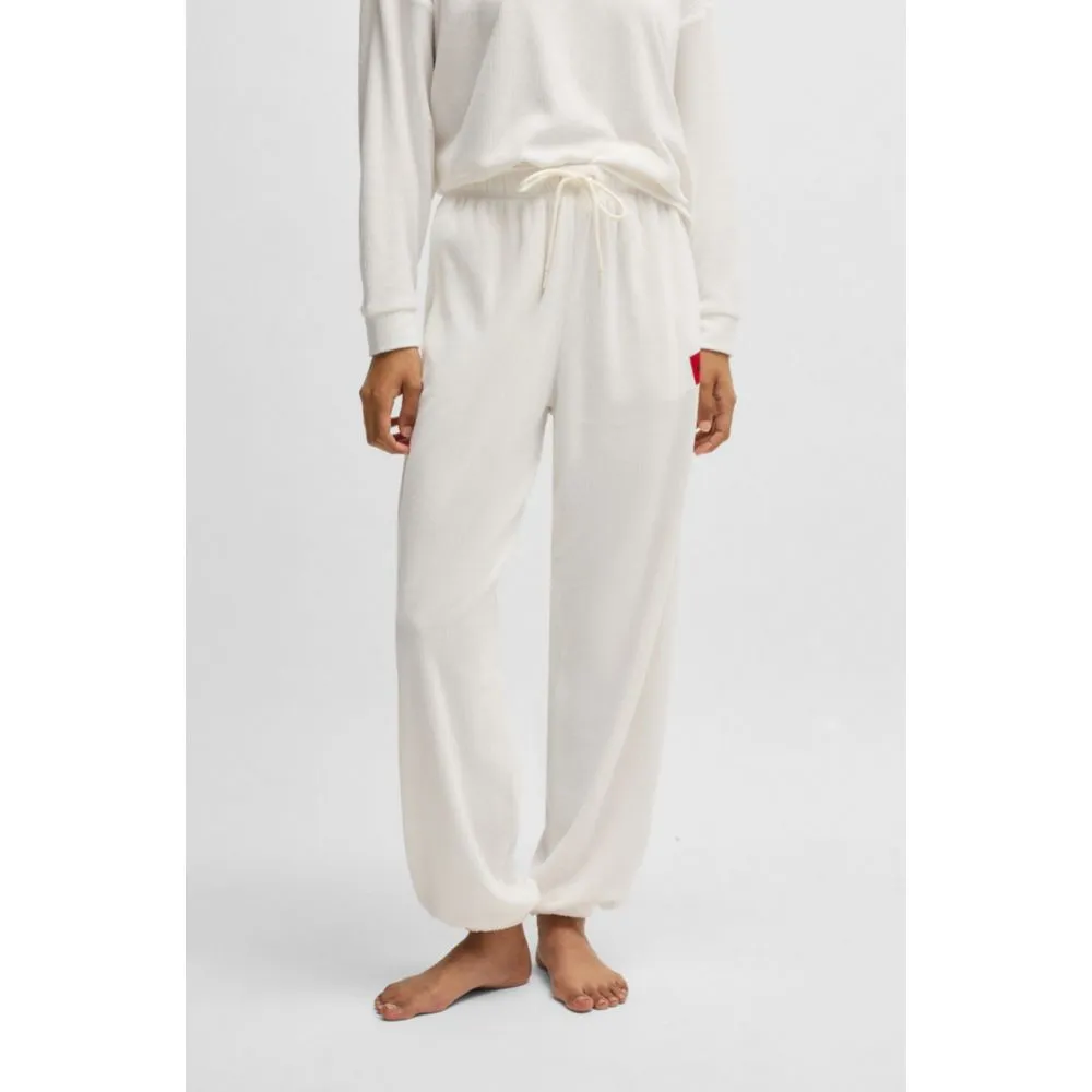 Tracksuit bottoms with red logo label